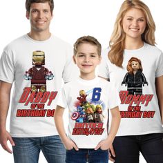 two children and an adult wearing matching t - shirts with the character iron man on them