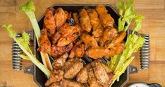 chicken wings, celery and lettuce on a grill with dipping sauce