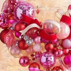 pink and red ornaments are arranged together