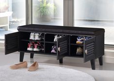 a black shoe bench with two cubbys underneath it