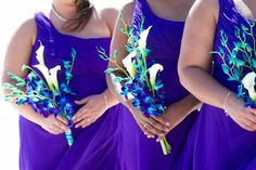 the bridesmaids are wearing purple dresses with blue and white flowers in their bouquets