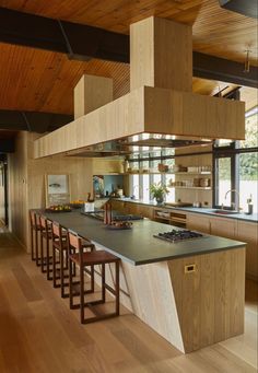 a kitchen with an island and wooden ceiling