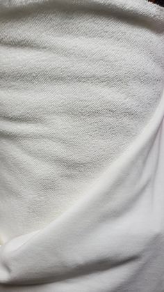 a close up view of the back of a person's stomach with white fabric on it