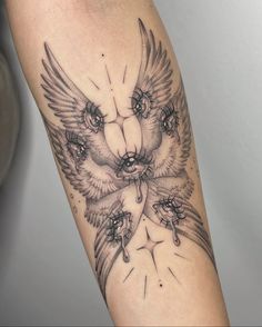 an owl and bear tattoo on the left arm is shown in black and grey colors