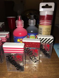 three clear boxes with red, white and blue designs on them sitting on a table