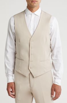 Bring understated elegance to the table in this three-piece suit crafted from rich fabric in a classic single-breasted silhouette. Jacket has notched lapels; chest welt pocket; front flap pockets Vest has front button closure; V-neck Pants have zip fly with button closure; front slant pockets; back button-welt pockets Jacket and vest are lined; trousers are lined to the knee 65% polyester, 35% viscose Dry clean Imported Suit has a 6” drop, meaning that a size 38R jacket is paired with size 32 pa Fitted Single Breasted Three-piece Suit With Notch Lapel, Semi-formal Slim Fit Single Breasted Three-piece Suit, Elegant Sets With Lapel Collar And Pockets, Elegant Sets With Pockets And Lapel Collar, Semi-formal Slim Fit Three-piece Suit With Single Button, Tailored Semi-formal Vest With Button Closure, Tailored Vest With Button Closure For Semi-formal Occasion, Semi-formal Slim Fit Three-piece Suit With Lapel Collar, Tailored Elegant Vest With Button Closure