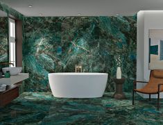 a bathroom with green marble walls and flooring, a bathtub in the center