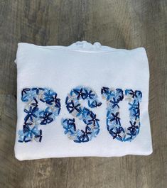 a white bag with blue flowers and the word doc on it is sitting on a wooden surface