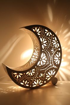 an intricately designed crescent lamp on a table