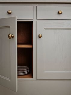 an open cabinet with plates in it