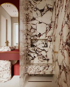 a bathroom with marble walls and flooring