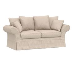 a beige couch with four pillows on it