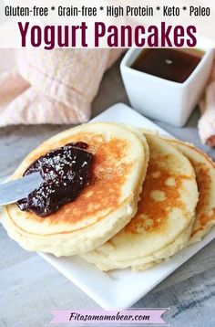 pancakes on a plate with syrup and butter in the background, text reads high protein yogurt pancakes