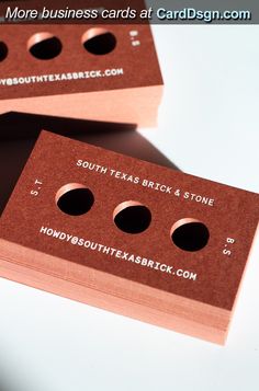 two business cards with holes in the middle