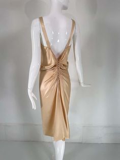 For Sale on 1stDibs - John Galliano, old Hollywood glamourous gold satin evening dress with a plunge V neckline and chiffon woven shirred center front, The back features a row