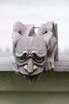 a gargoyle head on the side of a building