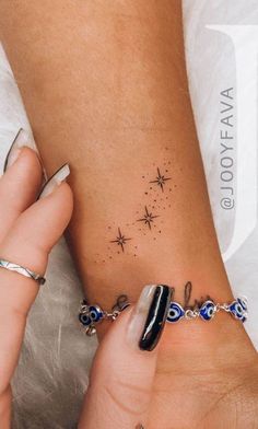 a woman's arm with a star tattoo on it