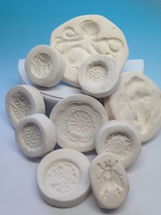 several white molds with designs on them