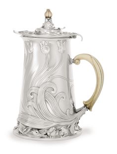 an ornate silver coffee pot with gold handles