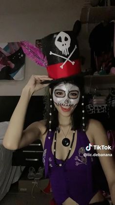 a woman wearing a pirate hat and makeup