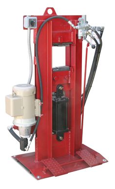 a machine that is sitting on top of a red stand with a hose attached to it