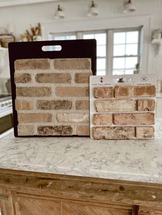 a kitchen counter with two bricks on top of it and a package of magnets