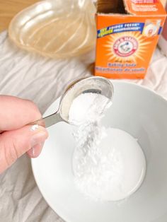 a person is spooning sugar into a bowl