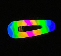 Get ready to light up the night with our mesmerizing resin hair barrette! This stunning hair clip not only boasts a rainbow design made with high-quality epoxy resin and glitter, but it also glows in the dark, making it a truly unique and eye-catching accessory. Crafted with love and attention to detail, this hair clip features a durable metal clip that ensures a secure hold, while the glowing resin design adds an extra element of fun and excitement to any outfit. Perfect for festivals, parties, or any night-time event, this resin hair barrette is a must-have accessory for anyone who loves to stand out in a crowd. So go ahead and add some sparkle and shine to your hair, day or night! Order now and get ready to glow like never before. Rainbow Hair Accessories, Led Hair Accessories, Glow In The Dark Hair Accessories, Epoxy Resin Hair Clips, Glowing Resin, Adjustable Fun Multicolor Hair Accessories, Rainbow Tie Dye, Light Up The Night, Neon Hair