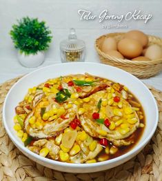 a white bowl filled with food on top of a woven place mat next to eggs