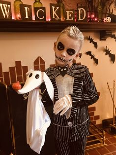 a skeleton dressed up in a suit and tie holding a white rabbit costume with black eyes