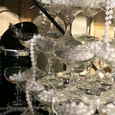 there are many wine glasses that have pearls on the rims and glassware in them