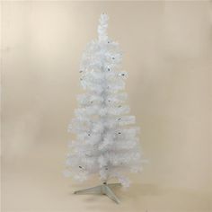 a small white christmas tree on a stand