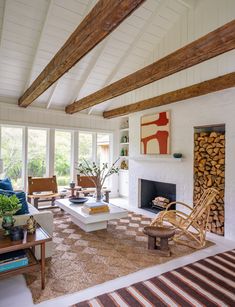 a living room filled with furniture and a fire place in the middle of a room