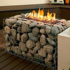 a fire pit made out of rocks and wire