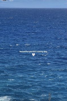 the ocean is very blue and has some small waves in it, with an inscription that reads beautiful perfect sunny day