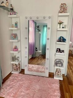 a mirror sitting on top of a wooden floor next to a shelf filled with books