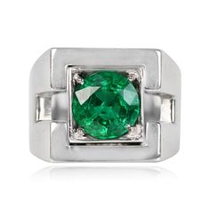 an emerald and diamond ring in white gold