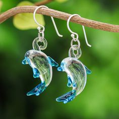 Show your passion for your favorite creature from the animal kingdom with this pair of charming earrings shaped like playful dolphins. Thai artisan Panapai employs the traditional handblown glass technique to craft these lovely accessories painted by hand with a subtle shade of blue and suspended from lustrous sterling silver hooks. Thailand Gifts, Glass Dolphin, Glass Earrings, Jewelry Packaging, Hook Earrings, Jewelry Gift Box, Charm Earrings, Hand Blown Glass, Free Jewelry