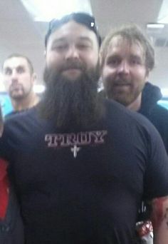 three men with long hair and beards are posing for a photo in front of the camera