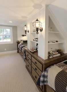 a bedroom with two beds and a book shelf in the corner on top of it