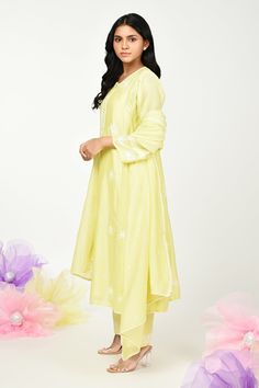 Yellow chanderi kurta with thread embroidery in floral placement pattern. Paired with cotton pant, inner and dupatta.
Components: 4
Pattern: Embroidery
Type Of Work: Thread, floral
Neckline: Round
Sleeve Type: Three quarter
Fabric: Chanderi
Color: Yellow
Other Details: 
Front button detailing
Lace embellished border
Embroidery on pant hem
Note: Potli shown in the image is not for sale
Occasion: Puja - Aza Fashions Spring Straight Kurta Anarkali Set With Floral Embroidery, Spring Straight Kurta Sets With Dupatta, Spring Floral Embroidered Straight Kurta Anarkali Set, Spring Sets With Straight Kurta And Dupatta, Spring Chanderi Palazzo Set With Straight Kurta, Spring Straight Kurta With Dupatta, Spring Anarkali Set With Straight Kurta And Dupatta, Spring Festive Mulmul Sets, Pista Green Chanderi Straight Kurta Set