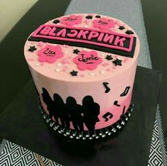 a pink and black cake with music notes on it