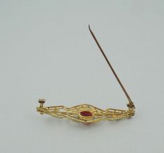 "Vintage 10K two color gold broach/pin set with a 1 carat oval created ruby. Beautifully balanced with flowers and petals, the two colors of gold bring a warmth to the deep red of the ruby. There is a very small chip near the girdle of the ruby but hard to see without magnification. This is a wonderful example of art in jewelry. FREE SHIPPING! Details: 10K Two Color Gold (shown in picture) Created Ruby: (1) 5 mm x 7 mm oval Stone Color: Ruby Red Approximate Stone Weight: 1 ct. Approximate Dimens Oval Yellow Gold Brooches With Gemstone, Oval Brooch In Fine Jewelry Style For Formal Occasions, Oval Hallmarked Brooch For Formal Occasions, Yellow Gold Oval Brooch For Wedding, Formal Oval Hallmarked Brooch, Formal Oval Hallmarked Brooches, Oval Gemstone Brooches For Anniversary, Oval Fine Jewelry Brooch For Gift, 14k Gold Hallmarked Brooches For Anniversary