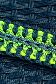 a green and black braided rope sitting on top of a table