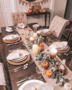 a dining room table set for thanksgiving dinner