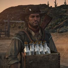 a man holding a crate full of bottles in front of a desert landscape with cactus trees