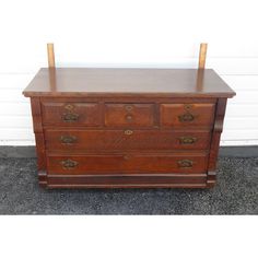 an old wooden dresser with four drawers