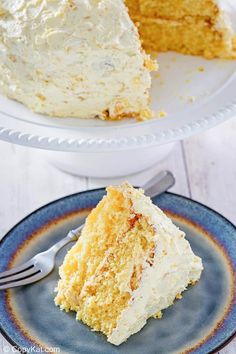 a piece of cake on a plate with a fork next to it and the rest of the cake in the background