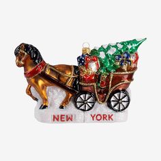 a christmas ornament with a horse pulling a sleigh filled with gifts