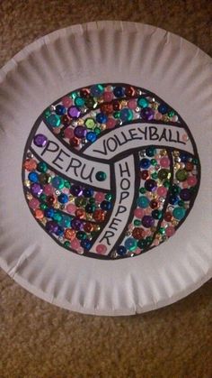 a paper plate that has some kind of volleyball on it with sequins around it